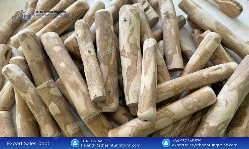 A pile of smooth 360-degree mechanically sanded organic coffee wood chews wholesale sticks