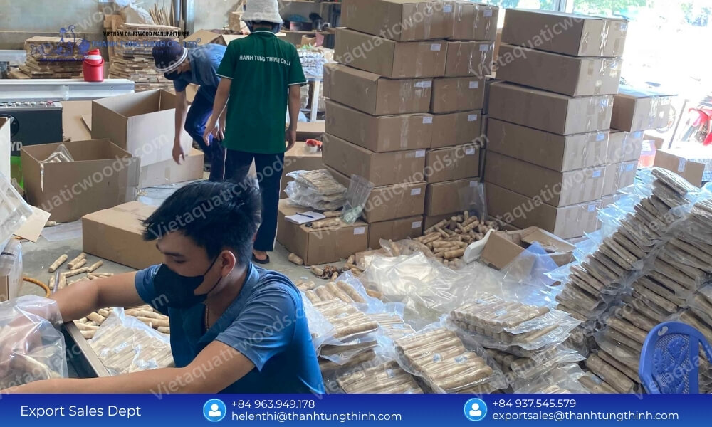 Staff applying custom shrink wrap packaging at our specialized coffee wood dog chew wholesale distributor facility