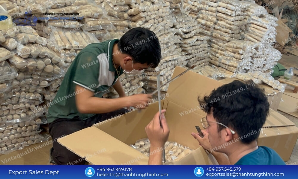 Factory workers carefully inspecting and packaging a bulk order of wholesale natural wooden dog toys for export