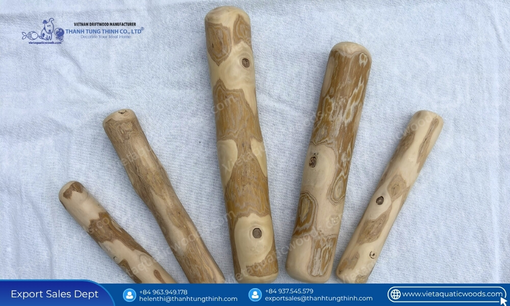 Five bulk coffee wood chew sticks assorted sizes placed side by side to show natural texture and length variations
