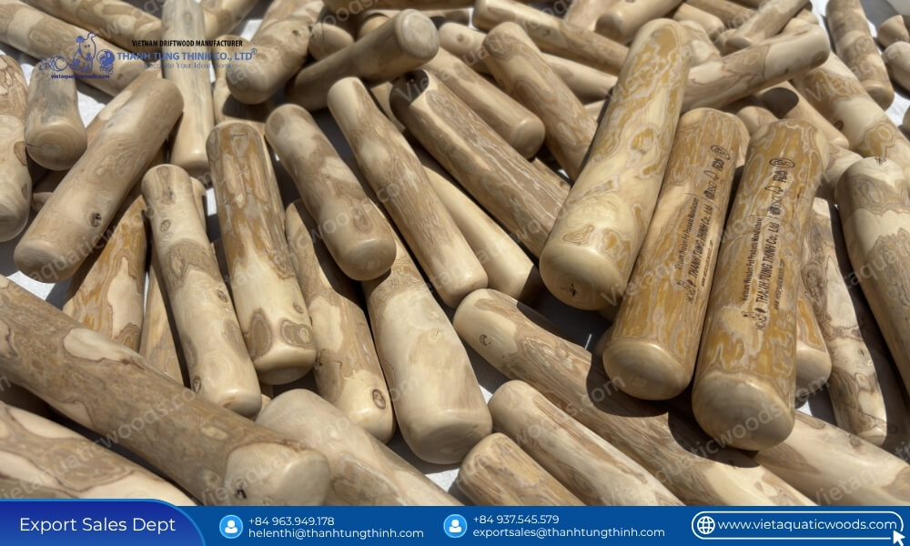 A pile of raw dried premium bulk coffee wood chew sticks assorted sizes showcasing smooth barkless surfaces