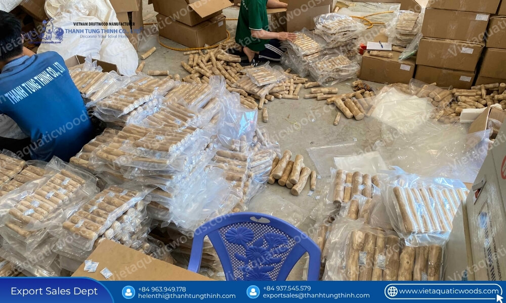 Workers sealing vacuum packages of bulk pet supplies coffee wood chew to prevent moisture during transport