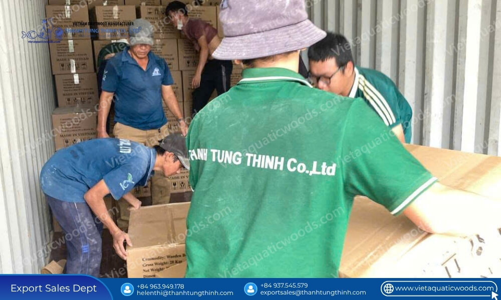 Workers reinforcing heavy cargo master cartons for international shipping logistics for bulk wooden dog houses