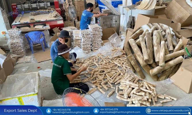Vietnamese craftsmen manually inspecting and rounding edges of bulk pet supplies coffee wood chew dog toys