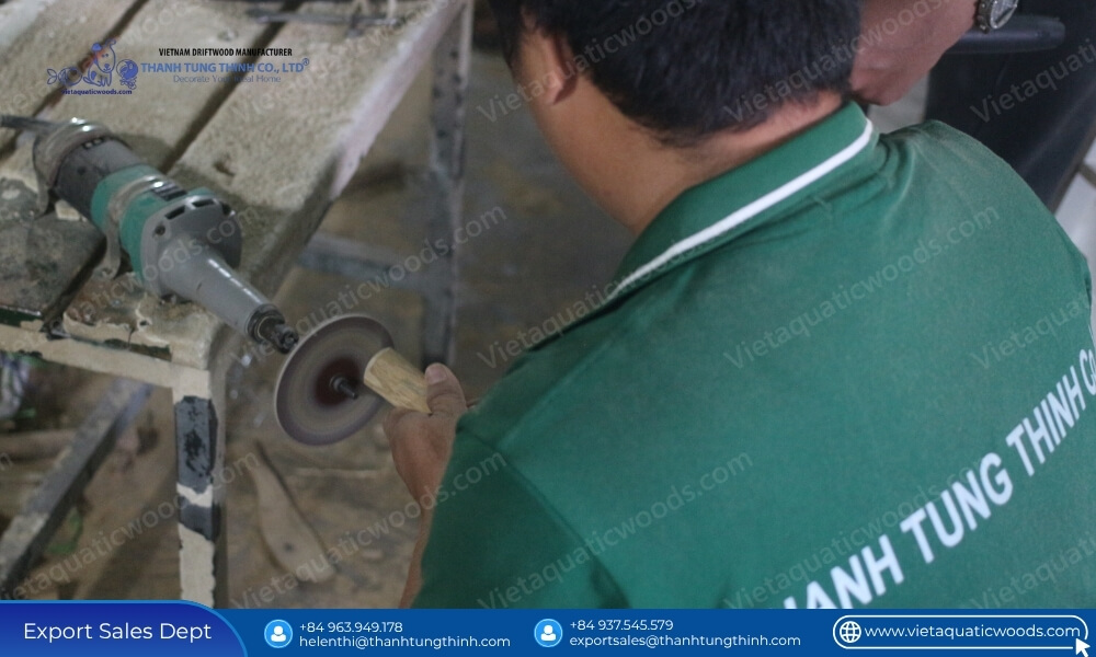 A factory worker sanding the rounded end of a piece of bulk coffee wood chew sticks assorted sizes for pet safety